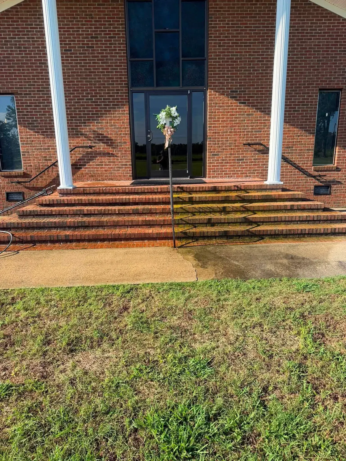 Brick entrance steps showing a cleaning contrast