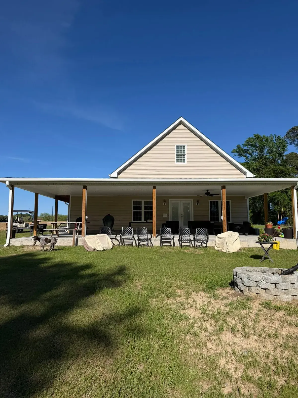 White gutter across a wide covered porch with downspouts at both ends