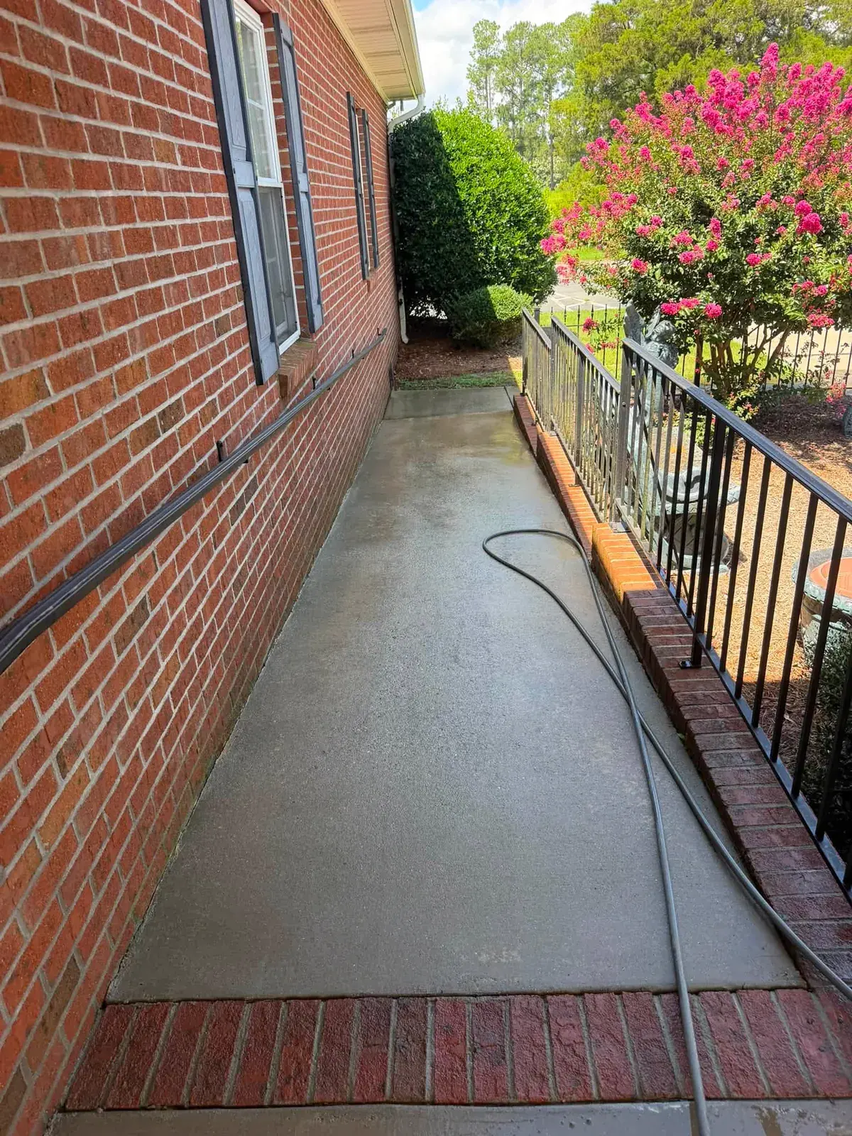 The same walkway after the wash, evenly light from the brick border to the house
